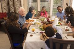 Family sitting at a dinner table - picture to illustrate how to represent yourself in family court