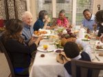 Family sitting at a dinner table - picture to illustrate how to represent yourself in family court